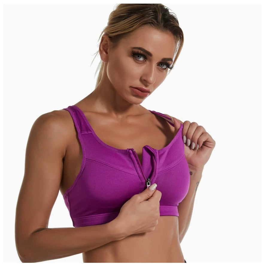 Woman zipping up the purple Bloom Zip Bra front-zip sports bra